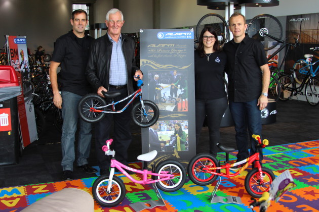 All in the family. From left to right Kim & John Struthers, Mandy Wilson and Stephen James. John is holding the second of two special Little Ripper bikes. The poster shows him presenting the first of these bikes along with a tiny jersey to the Duke and Duchess of Cambridge as presents for Prince George.